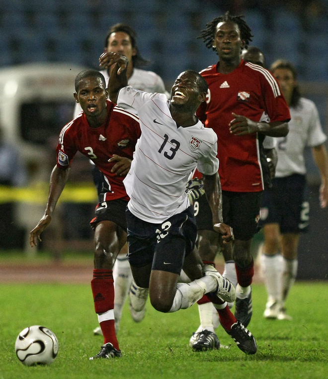 US football player midfielder Maurice Edu (Center) is tackled by Trinidad and Tobago' s defender Aklie Edwards (L) and midfielder Keon Daniel during their FIFA World Cup South Africa-2010 qualifier football match at the Hasely Crawford stadium in Port of Spain, on October 15, 2008. AFP PHOTO / THOMAS COEX (Photo credit should read THOMAS COEX/AFP/Getty Images)